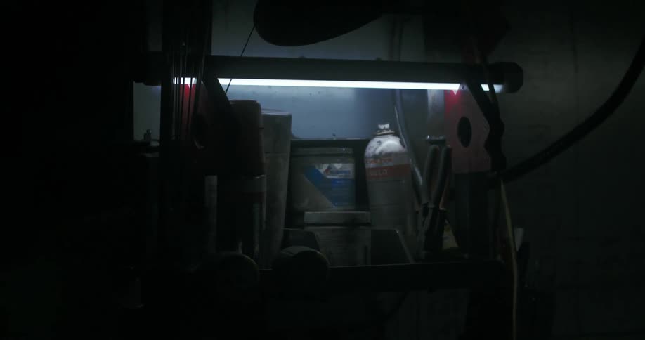 A shelf underneath a fluorescent light