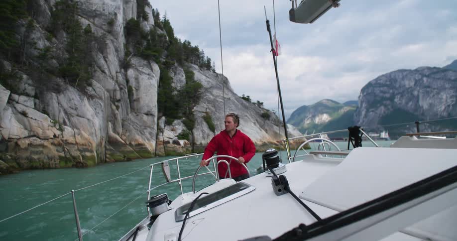 A man steers his boat through the water