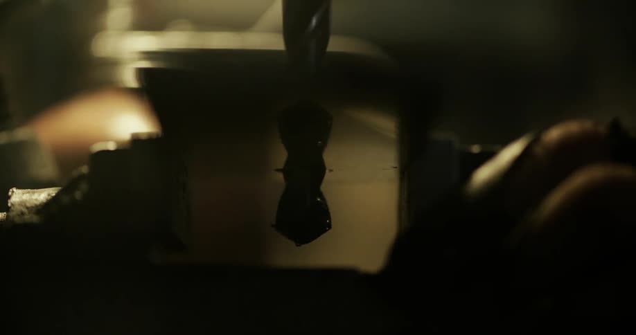 A drill bit spins in the air
