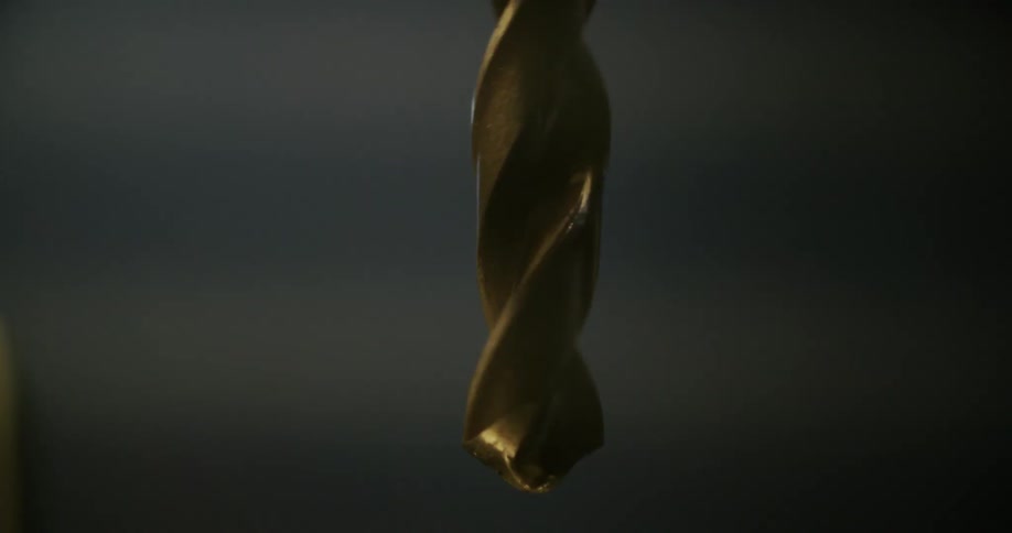 Drops of water dripping from a drill bit