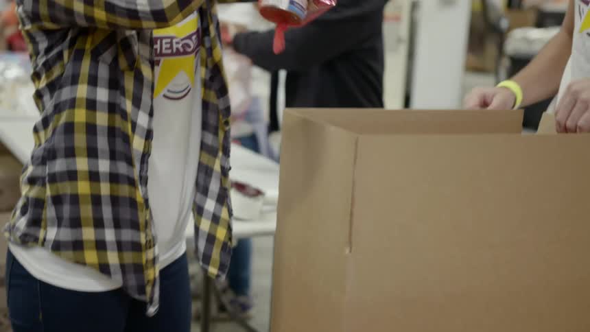 A person putting food into a box