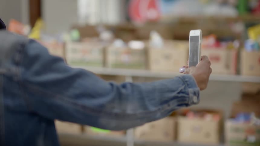 A woman takes a selfie on her phone