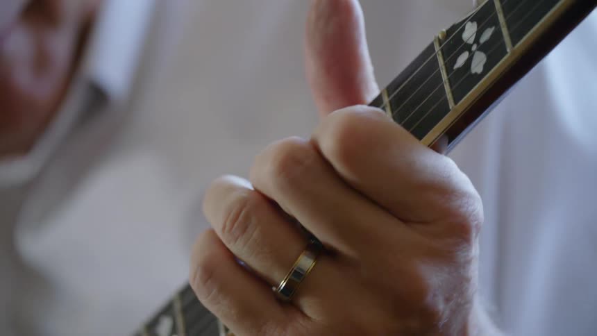 A man is playing guitar indoors
