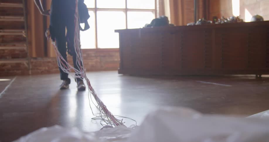 A person throwing a dress onto the floor