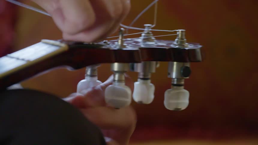 A musician tunes a guitar