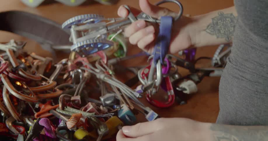 A woman picks up a strange hand device and plays with it