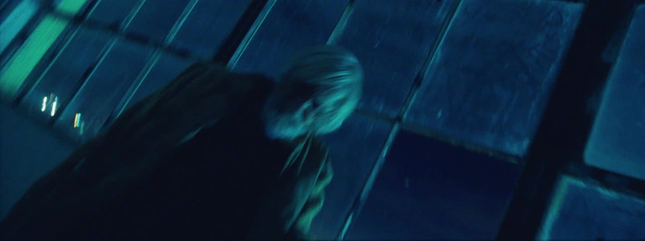 An elderly man frantically waves his arms in a hospital hallway