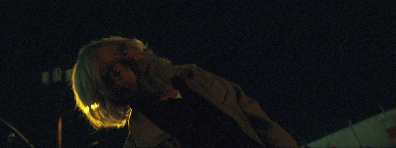 Beggar asks for money outdoors at night