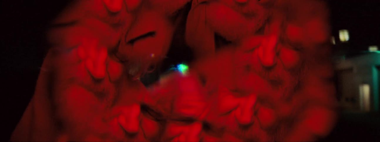 An elderly crying man is seen through a kaleidoscope type lens
