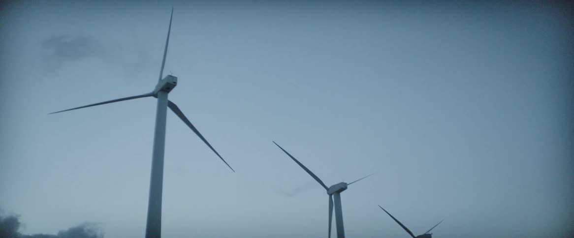 The blades of wind turbines turn slowly