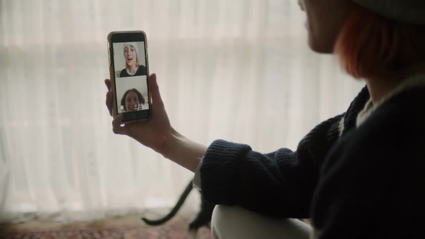 Three women speak over video