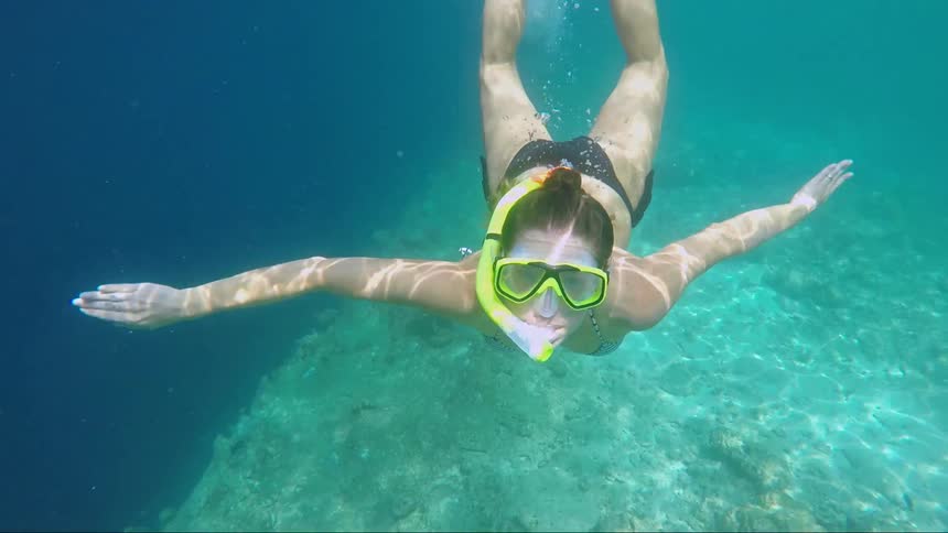 A young girl snorkels