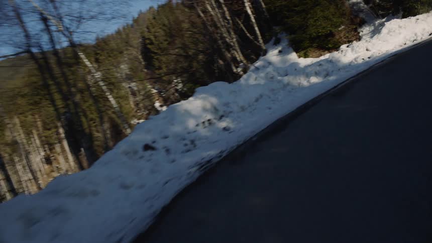 Vehicle drives through a sharp bend on the mountain road