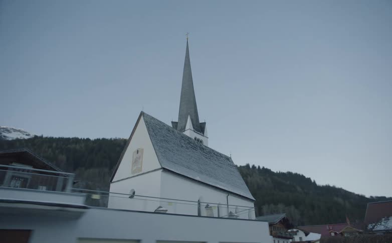A church sits at the base of a hill
