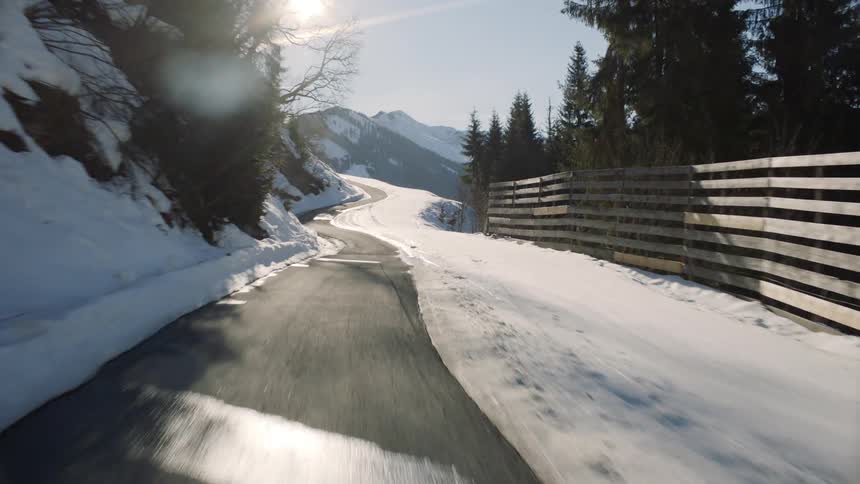 A snowy mountain road on a sunny day