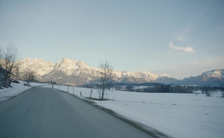 A road runs toward a mountain in the countryside