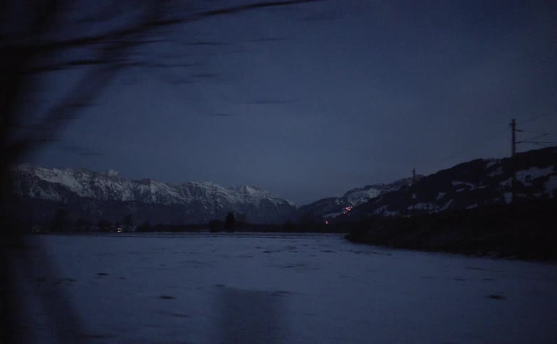 The snow covered field leads to a mountain range