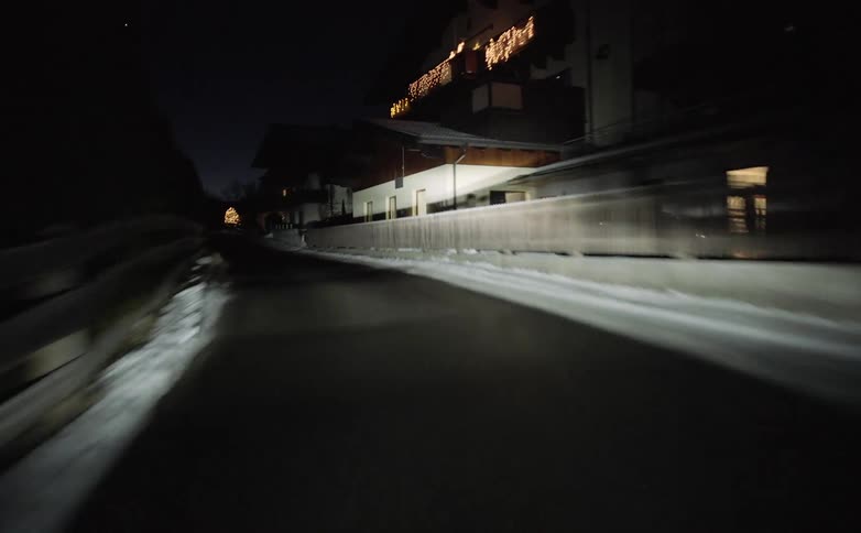 Vehicle drives through the countryside at night