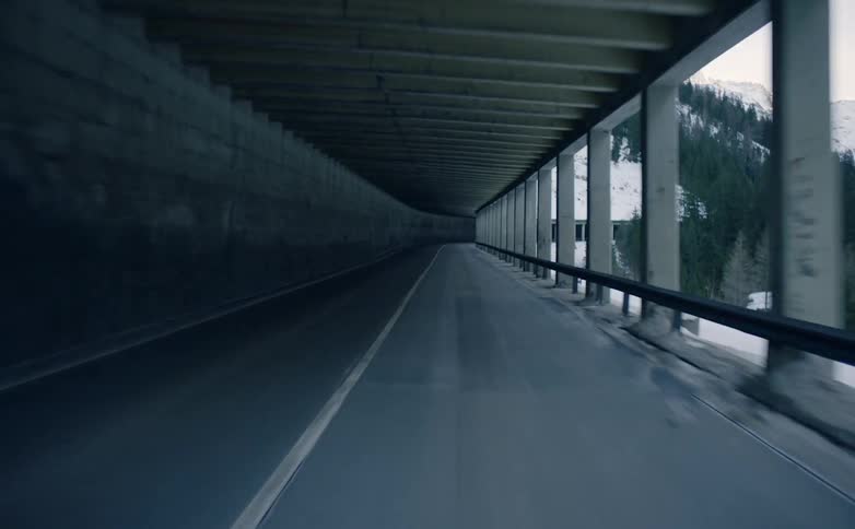 A tunnel road runs along the side of a mountain