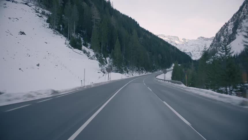 A dashcam shot of a car on a mountain road