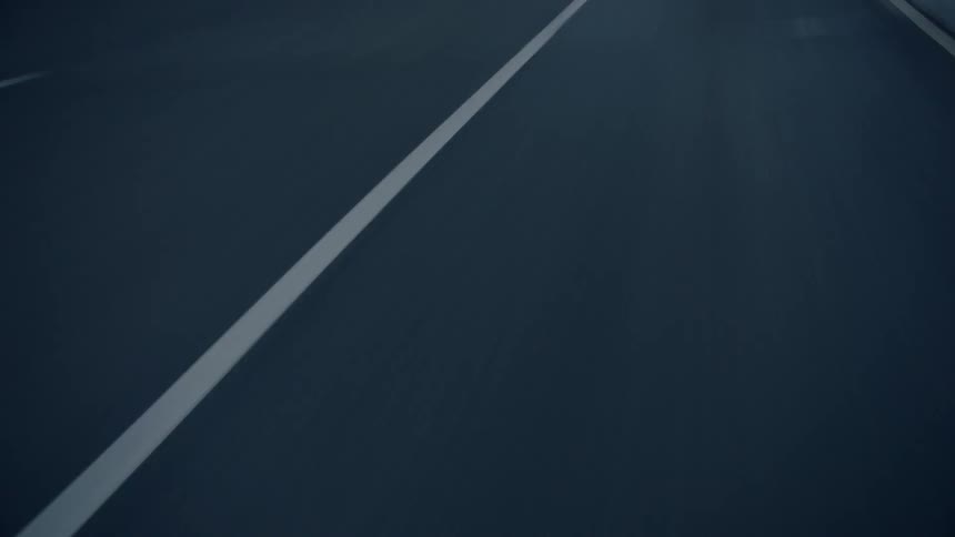 Vehicle drives along road in the snowy mountains