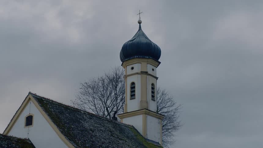 The spire of a church reaches toward the sky