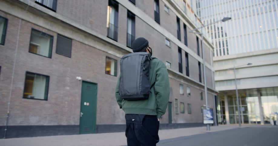 A man wearing a mask walks down an empty street