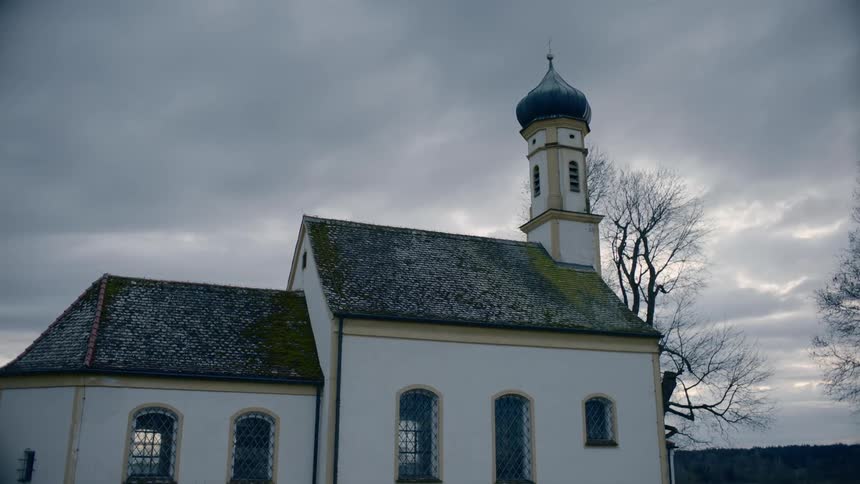 A small church in a rural area on a cloudy day