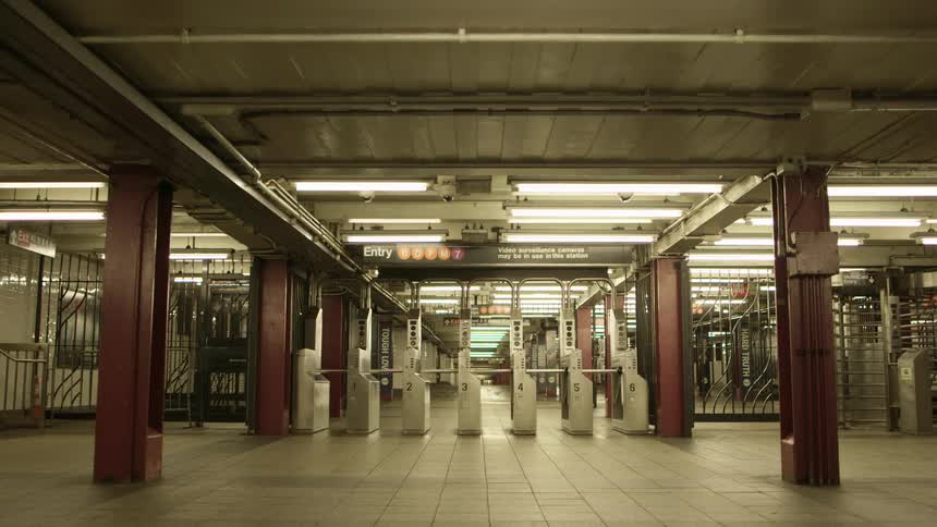 A lone person walks through empty transportation station