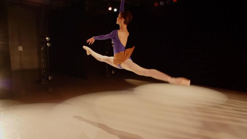 Ballerina practice leaps across the stage