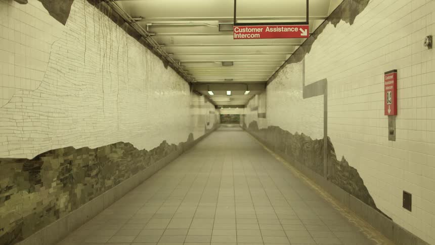 A long hallway with tiled floor and walls