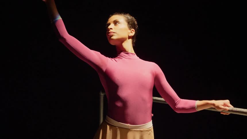 Female ballerina performs ballet in the spotlight on the stage