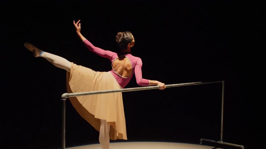 Female ballerina performs ballet in the spotlight on the stage