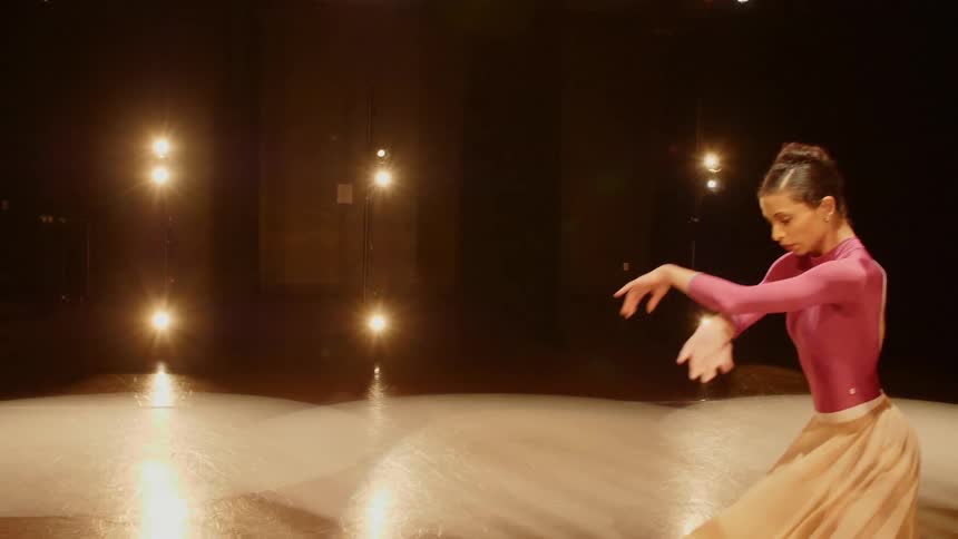 Female ballerina performs twirls and dance moves