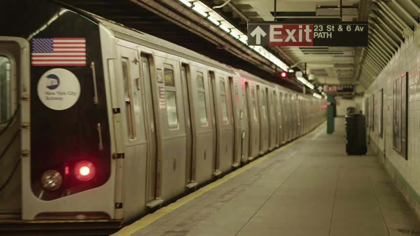 A subway train pulls out of the 23rd street station leaving an empty platform behind