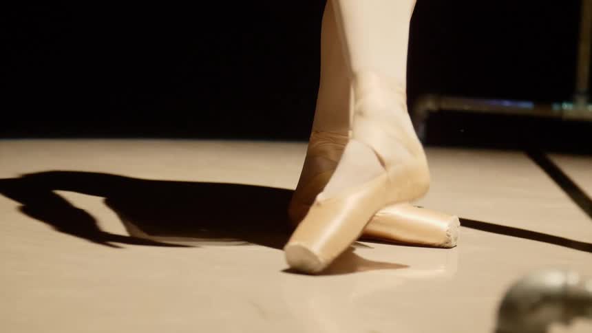 A woman feet with ballerina shoes on dancing