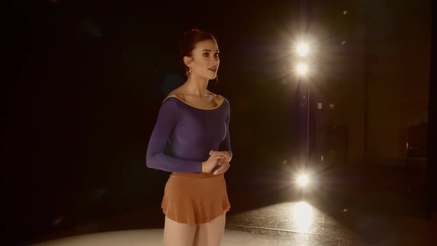 Nervous dancer standing on stage talking to judges