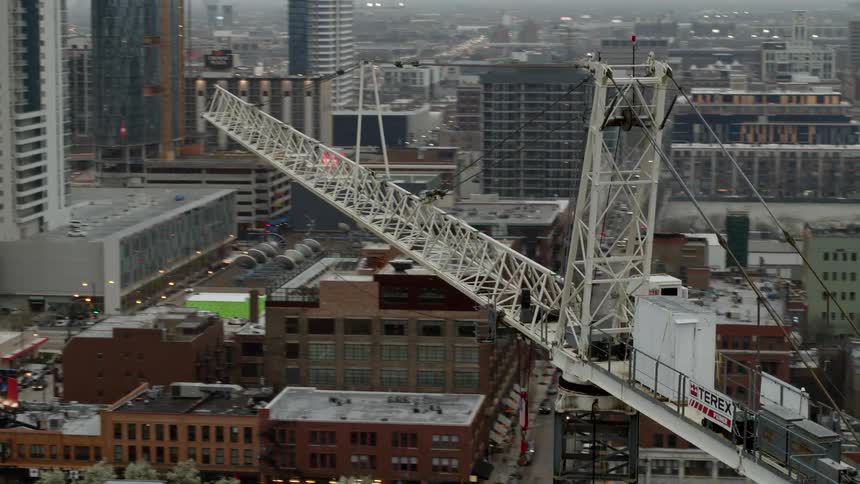 A construction crane sits between buildings