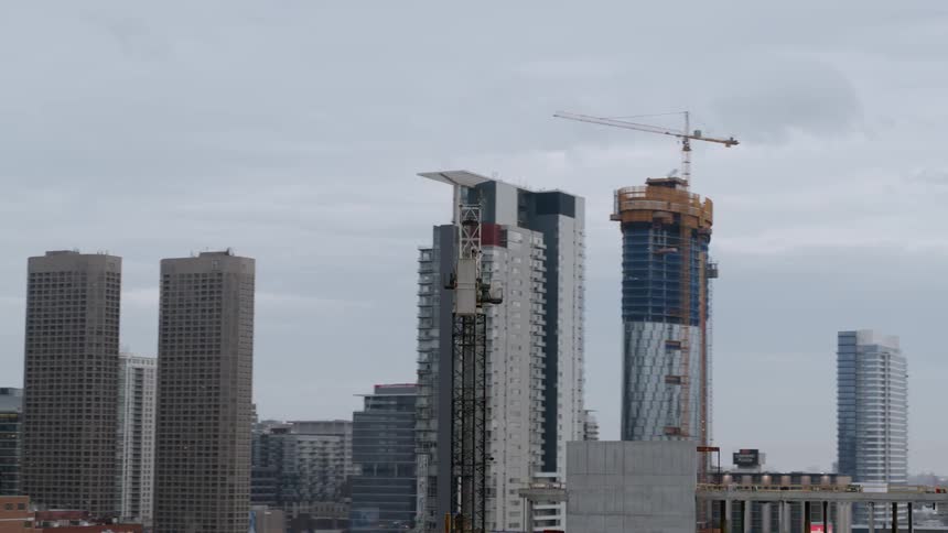 Construction cranes next to skyscrapers in Chicago
