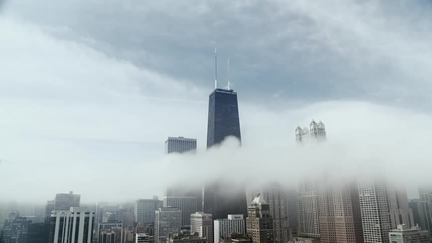 Clouds cover skyscrapers in a downtown Chicago