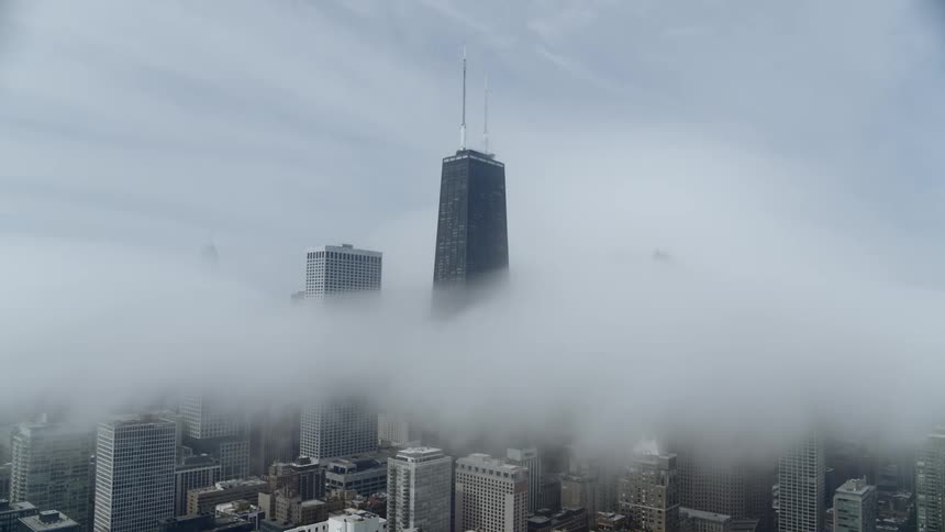 A layer of fog hangs over Chicago skyline