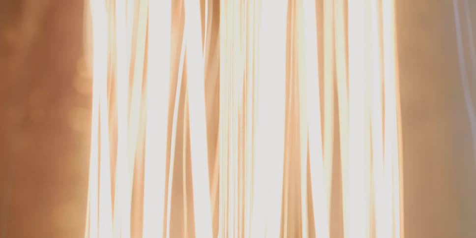 Close up of a light bulb filament turning on and off