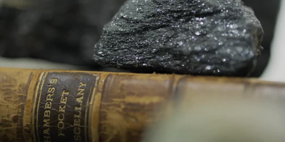 A rock sits on top of a book