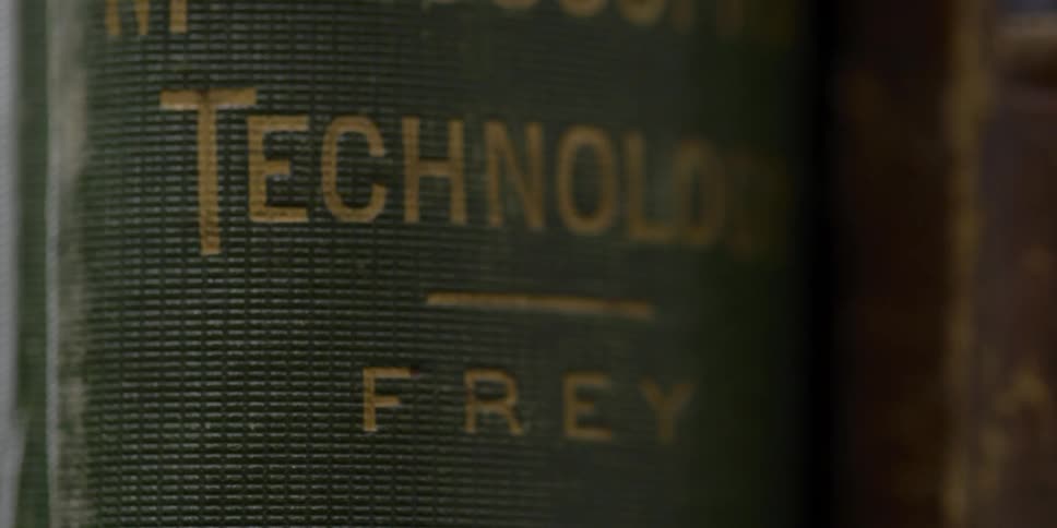 A book on a shelf bound in green reading technology