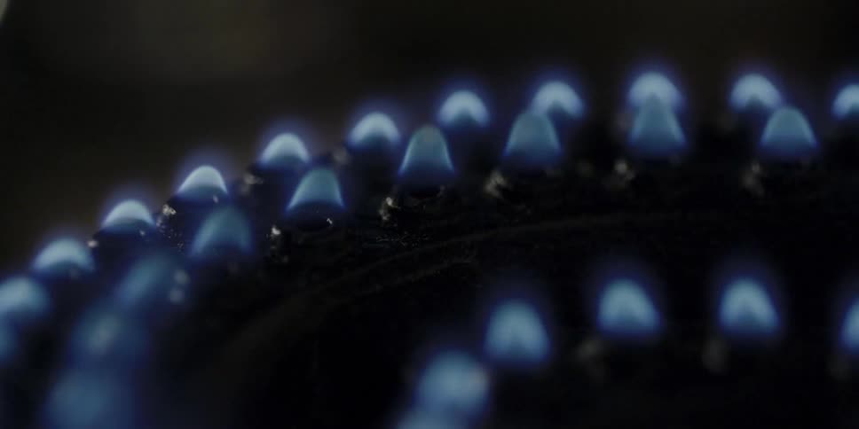 Close up of flames flickering on and off on a stove top
