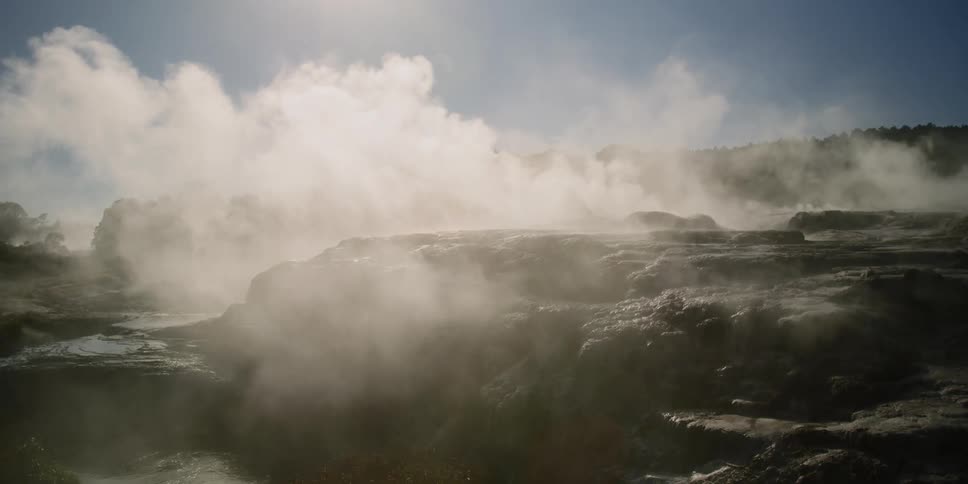 Steam rises from a spring in a canyon