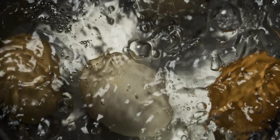 Eggs boil in pan of water