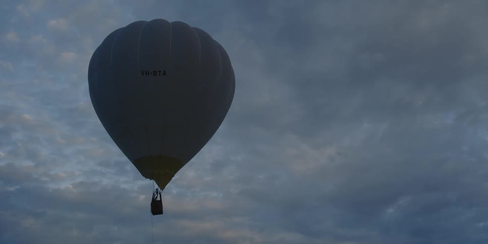 A hot air balloon floats through the sky