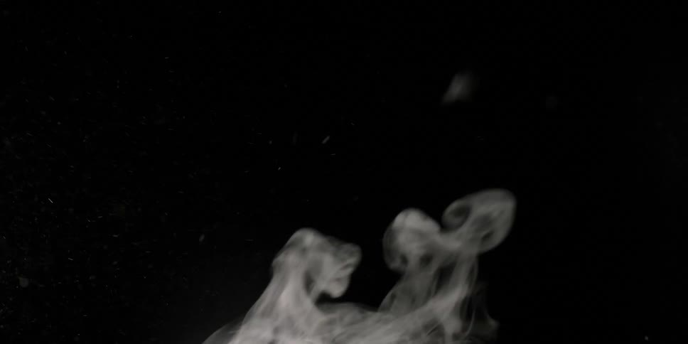 Steam rises and swirls in the air against a black background