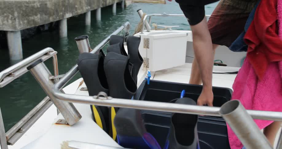 A man looks through a tote and pulls out towels